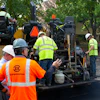 A crew on a parking lot project in Indianapolis prepares to lay asphalt that includes Invigorate Additive.