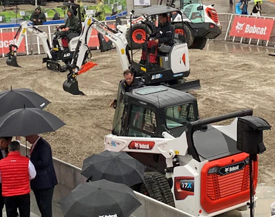 A pair of newly launched Bobcat E19e excavators swung and scooped in synchronized motion at the Bobcat outdoor booth at bauma 2022 in Munich, Germany, on Monday, Oct. 24.