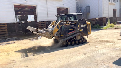 Crews used a 1,925-pound-rated operating capacity ASV MAX-Series RT-65 compact track loader to pry up and haul out floor sections.
