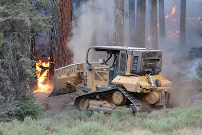 Dozers used in firefighting are being outfitted with guarded lighting, an oil-level sight glass, fuel-shut off in the cab, onboard fire suppression, and pressurized cab systems with HEPA filtration to keep leftover smoke and burnt ash out of the driver’s lungs.