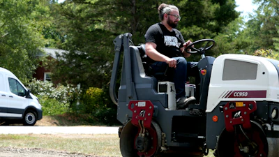 Brandon Noel, Editor, compacting gravel base for a driveway.