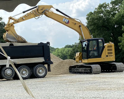 A 325 excavator demonstrates payload indication during the breakout sessions.