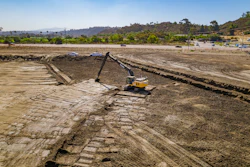 The operator uses an excavator with grade control to complete delicate earthmoving work at the San Dieguito Lagoon project.