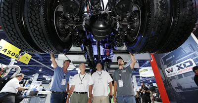 Attendees examine equipment up close on the show floor.