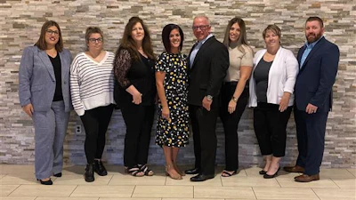 The staff of the Allied Trades Assistance Program. From left to right Naomi Margiotta (Claims Representative), Robyn Tutela-Zarli (Client Care Representative), Marianne Kochersperger (Claims/Client Care Representative), Marianne Wolfe (Managed Care Supervisor), Ken Serviss (Executive Director), Heather Russell (Senior Client Care Coordinator), Tina Rowan-Coll (Client Care Manager), and Joe Carey (ILA Pier Counselor).