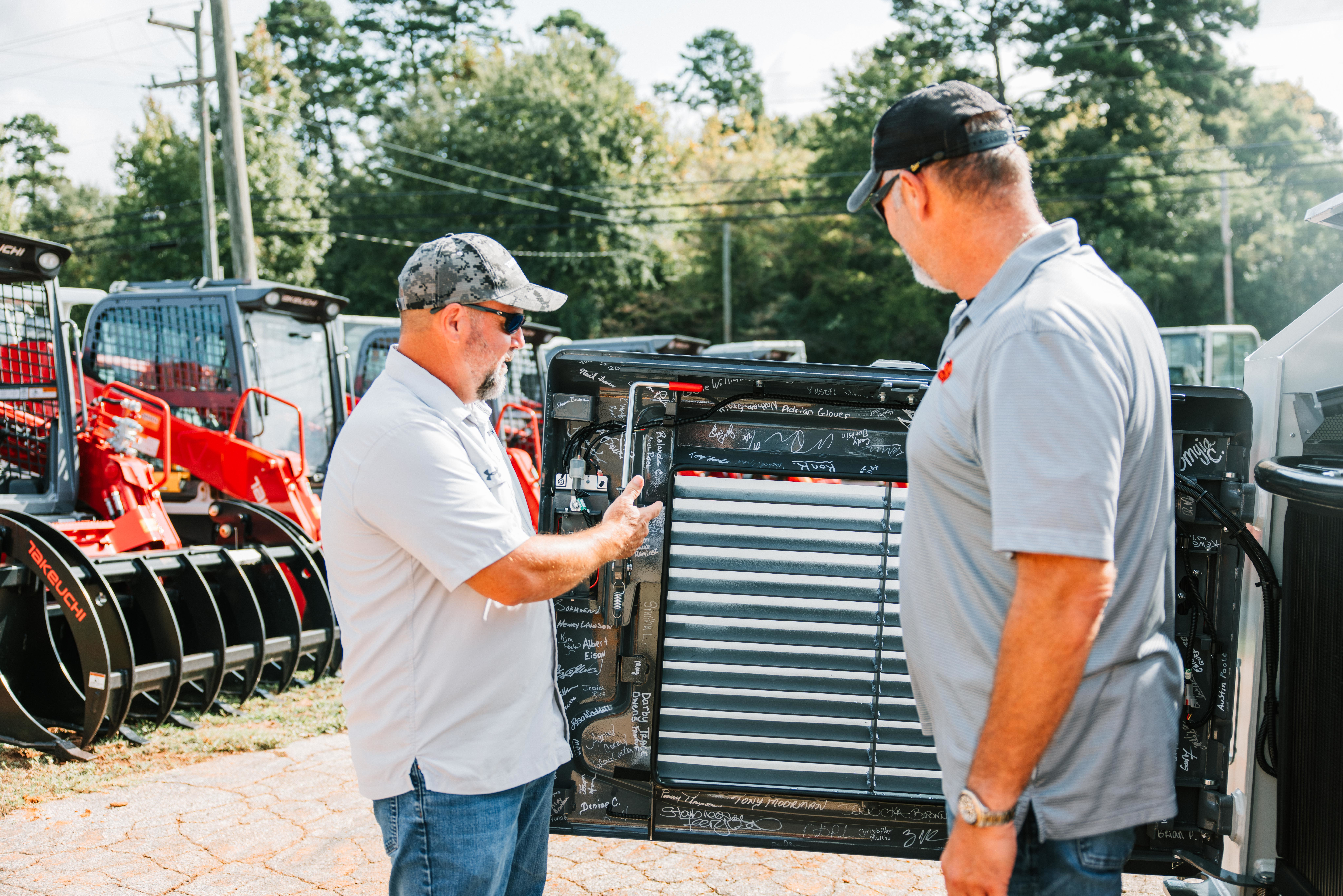 Takeuchi’s Moore employees signed the interior engine cover of the 10,000th CTL, making it a once-in-a-lifetime purchase.