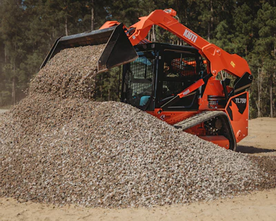 Powered by a 74-hp diesel engine, the machine offers two-speed travel, pilot hydraulic joystick controls, rearview camera, sliding overhead door and LED work lights.