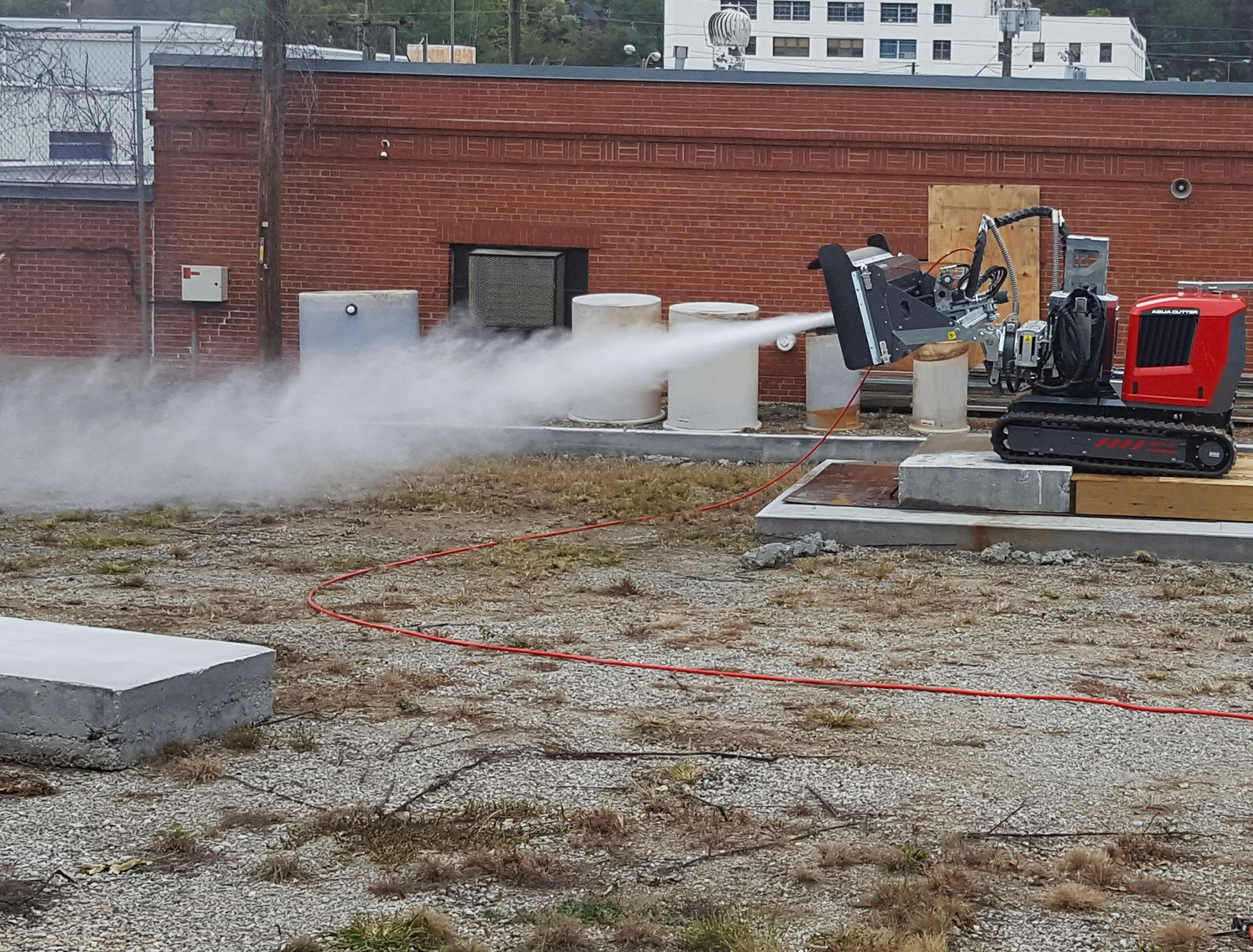 Controlling a water jet through mechanical means was a safer, faster, more sophisticated way to remove concrete compared to a jackhammer or hand lance.