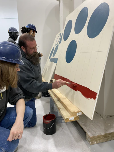 John Burcaw teaching students at the institute's Finishing Trades Academy which include the trades commercial painter, industrial painter, drywall finisher, glazier, and glassworker.