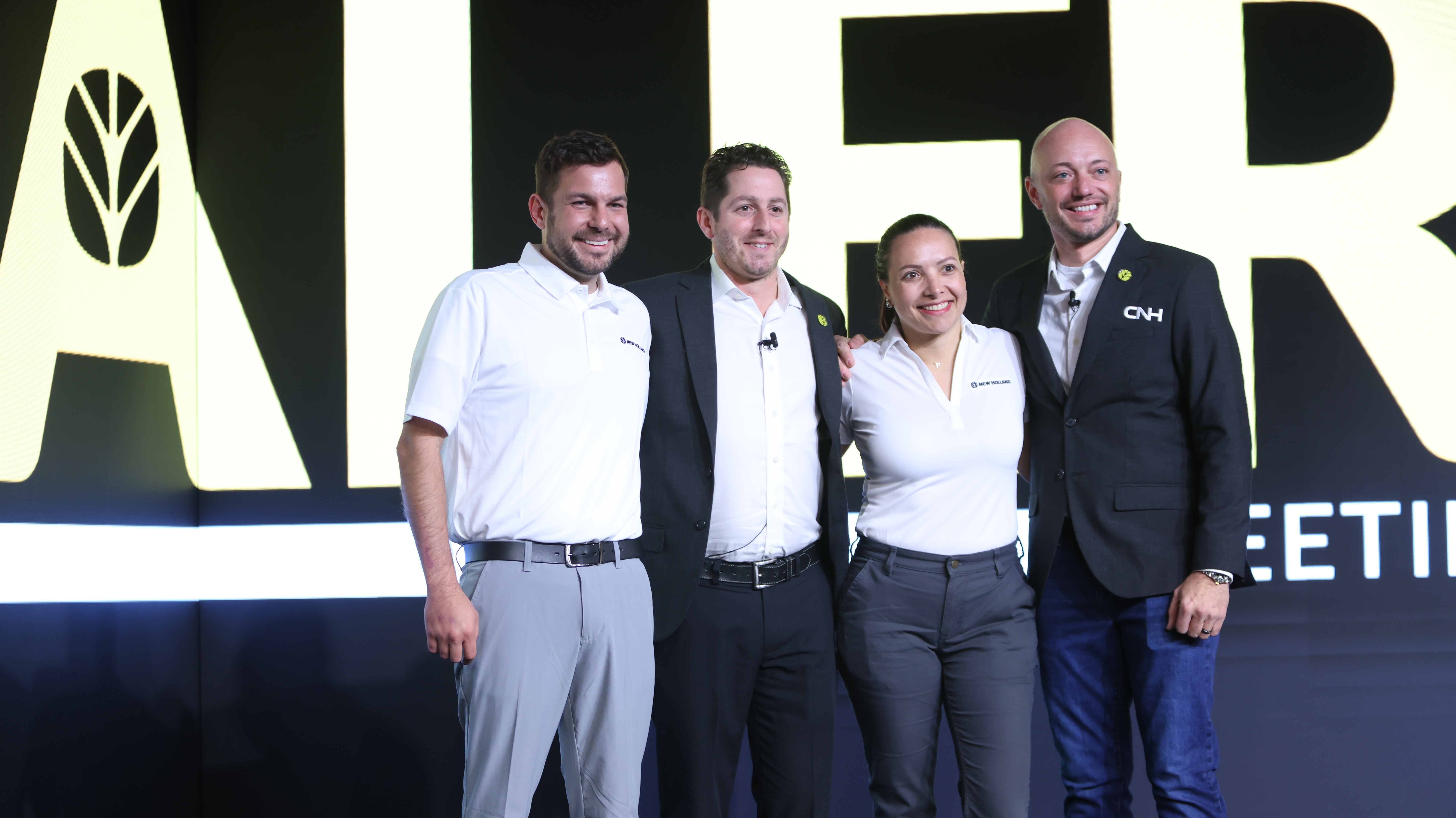 Brian Weisbaum (second from left) poses at the 2025 New Holland Construction National Dealer Meeting, where he outlined his vision for strengthening dealer relationships and expanding digital retailing.