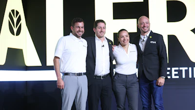 Brian Weisbaum (second from left) poses at the 2025 New Holland Construction National Dealer Meeting, where he outlined his vision for strengthening dealer relationships and expanding digital retailing.