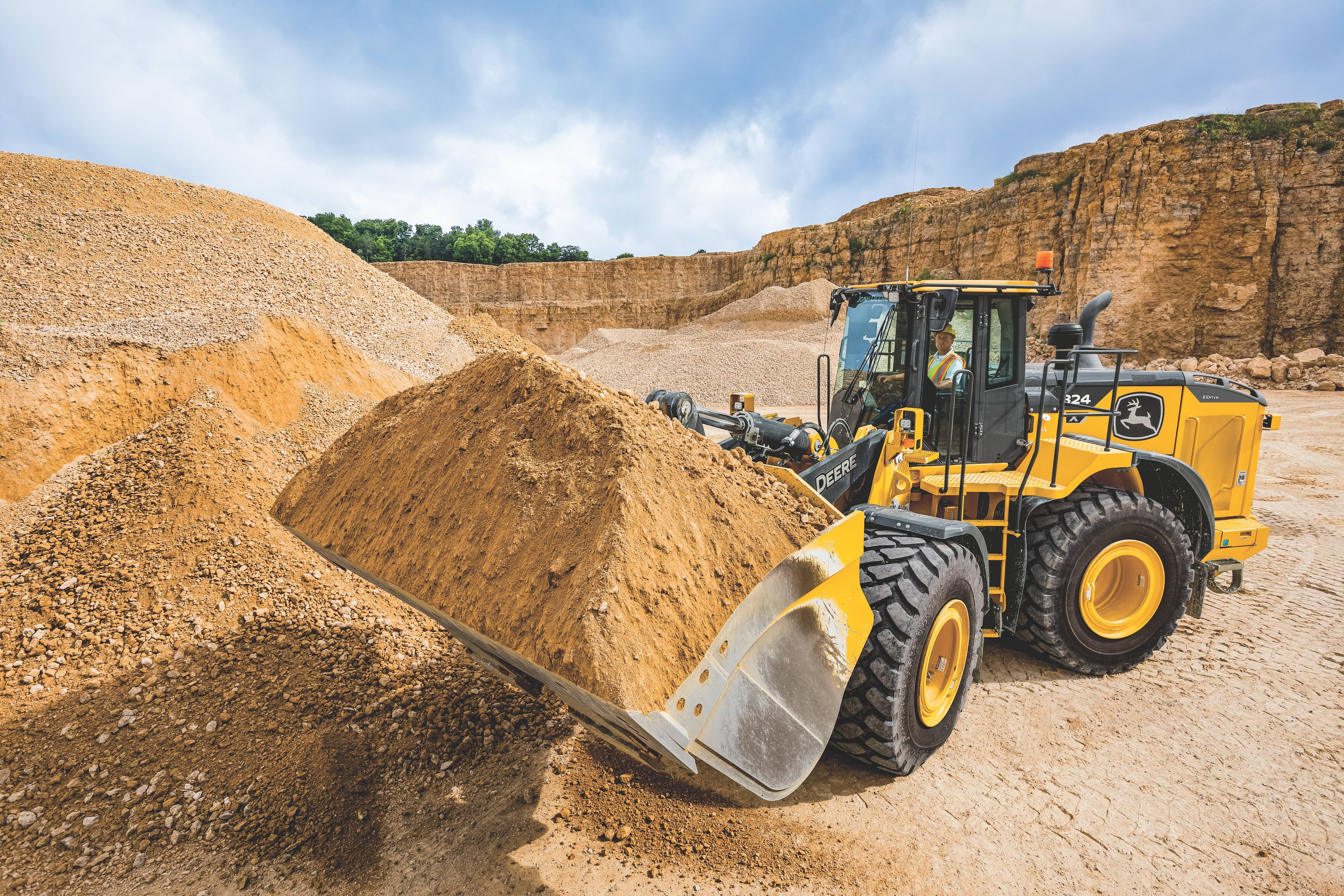 John Deere's new 824 X-Tier loader features the John Deere Electric Variable Transmission (EVT) E-Drive system. It is equipped with a JD9 diesel engine as the primary power source, however, the torque converter and traditional transmission have been replaced by the EVT system. In addition, the E-Drive component provides instant power, while simplifying operation and reducing complexity.