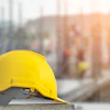 Yellow construction safety helmet on concrete at building site