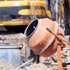 Orange cement mixer at construction site