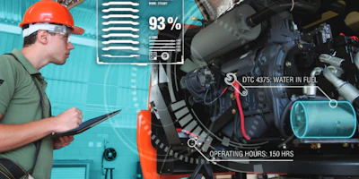 Industrial technician monitoring machinery with digital diagnostic interface showing engine performance