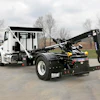 Stellar hook lift truck with hydraulic arm on industrial work site