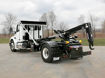 Stellar hook lift truck with hydraulic arm on industrial work site