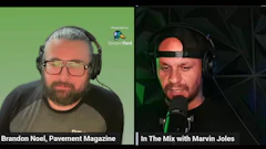 Two podcast hosts in headphones during a livestreamed interview