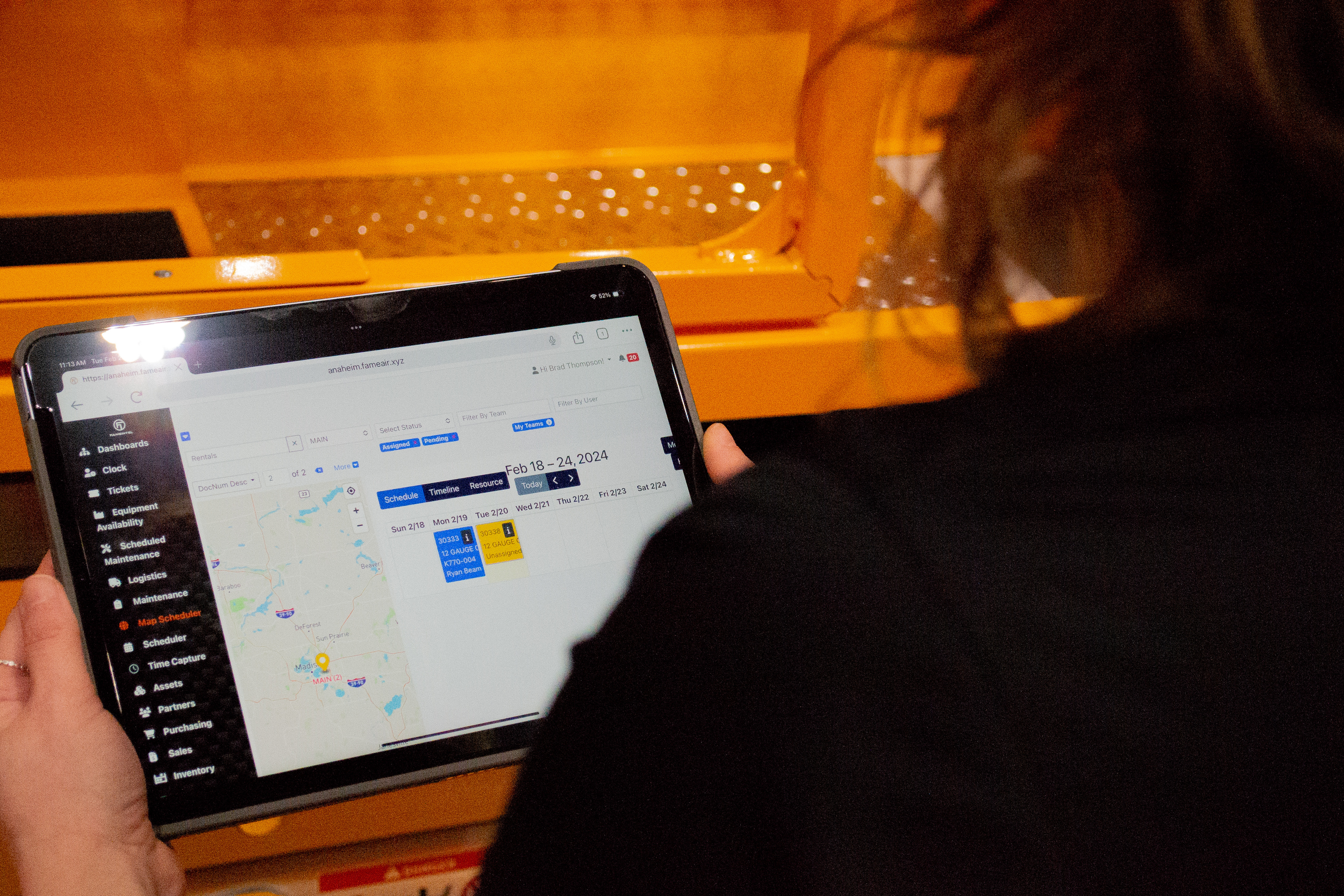 Person viewing digital map or scheduling interface on tablet screen