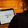 Person viewing digital map or scheduling interface on tablet screen