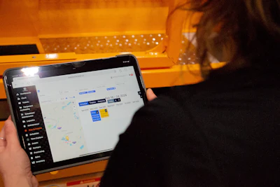 Person viewing digital map or scheduling interface on tablet screen