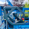Close-up of grey control joystick mounted on blue Genie GS-1932m aerial lift platform equipment