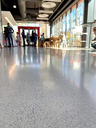 Low-gloss polished concrete floors offer a softer, more natural aesthetic while maintaining durability and easy maintenance.