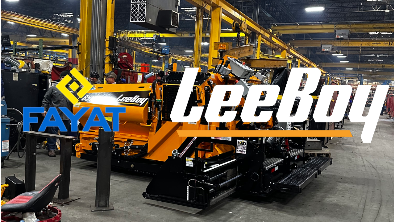Yellow Leeboy paving machine in industrial manufacturing facility