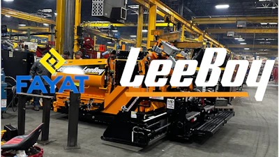 Yellow Leeboy paving machine in industrial manufacturing facility