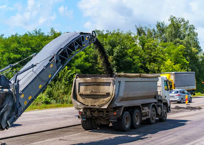 Road construction site with dump truck and asphalt milling machine