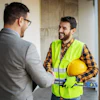 Construction worker in safety vest talking with colleague in office setting