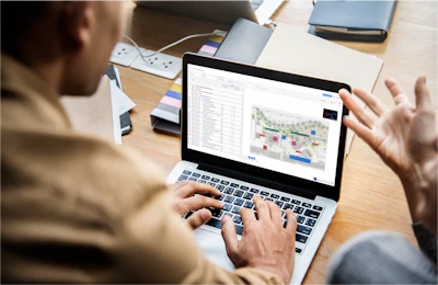 Professional analyzing data visualization on laptop at workplace desk
