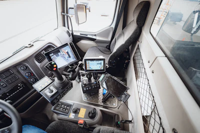 Commercial truck dashboard with multiple digital screens and control interfaces