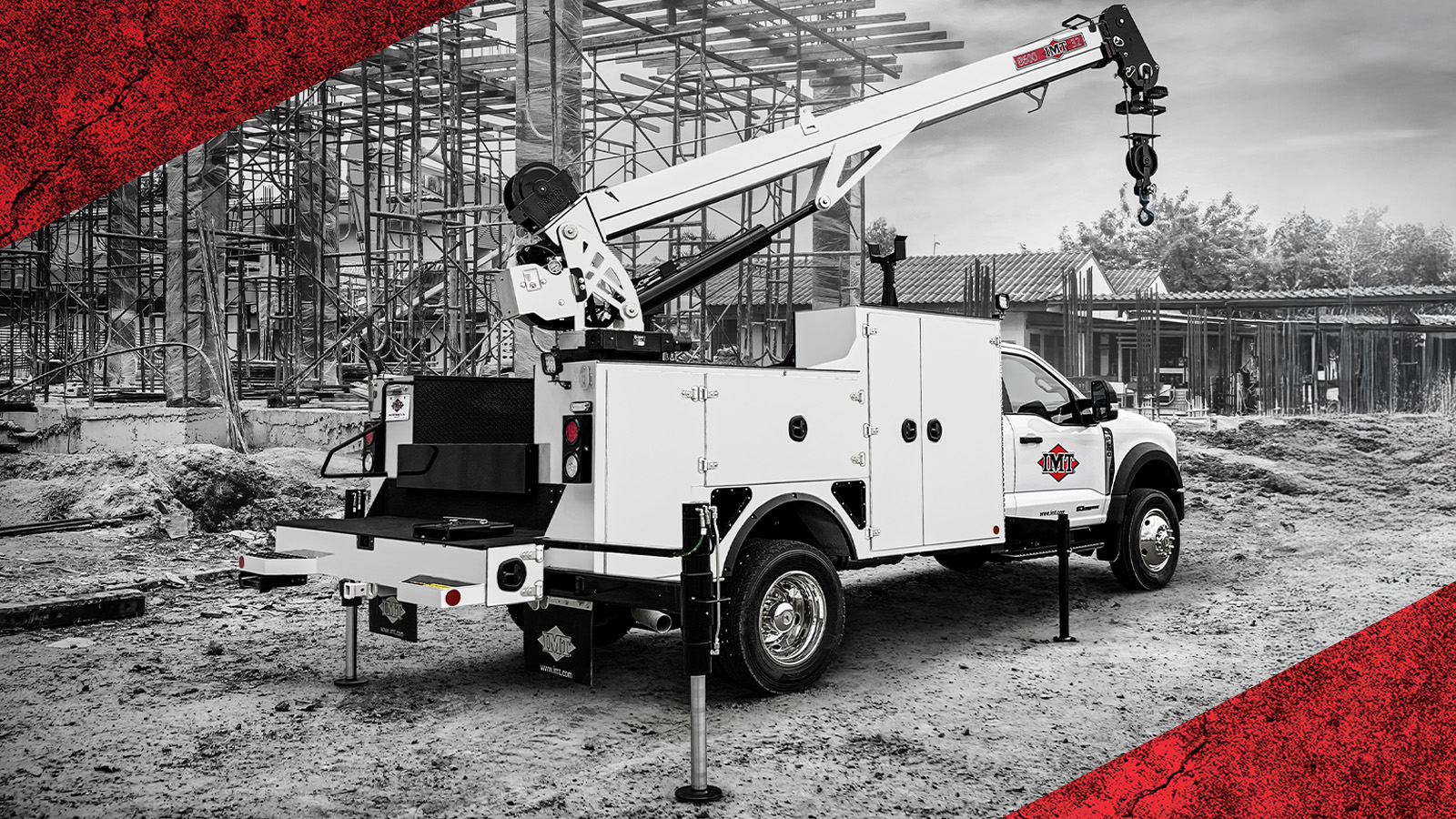 White utility service truck with crane at construction site with scaffolding