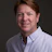 Professional headshot of a smiling man in a white button-down shirt Headshot