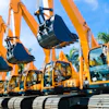 Fleet of bright orange hydraulic excavators lined up with palm trees