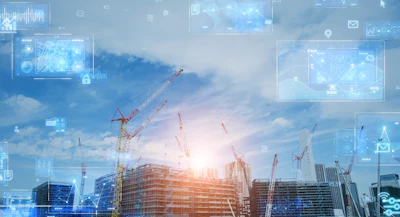 Construction site with cranes and digital technology interface overlay at sunset