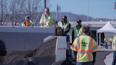 Construction workers operating heavy machinery at an outdoor work site