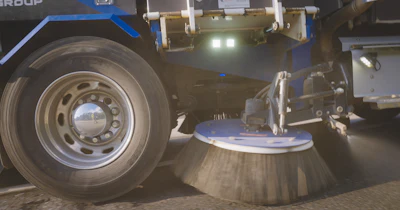 Street sweeping vehicle with rotating side brush cleaning surface