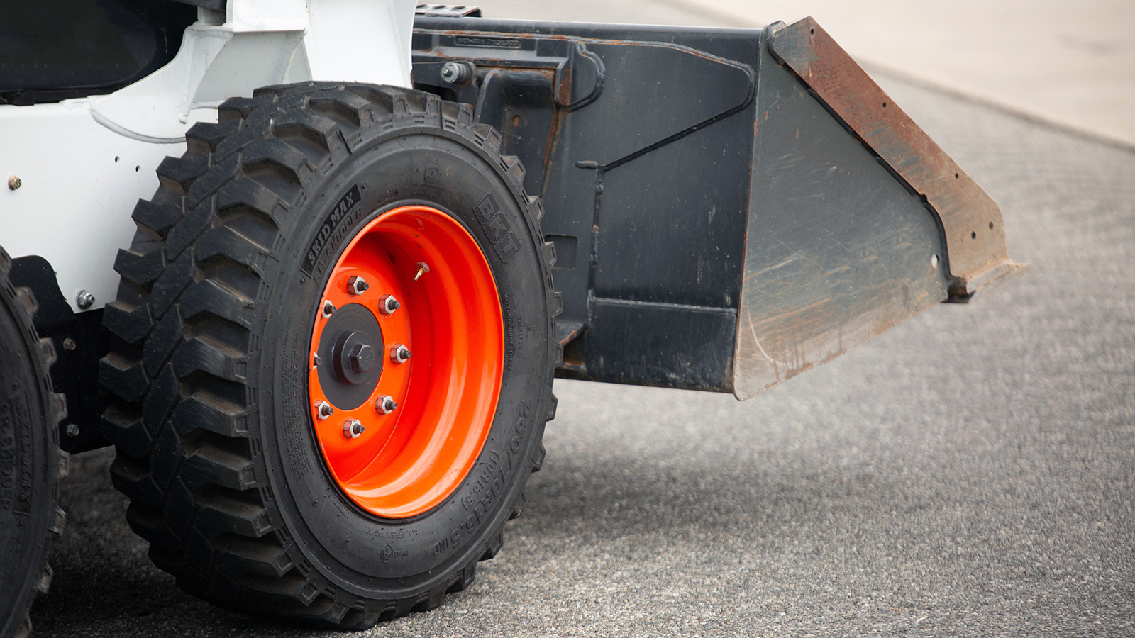 Industrial wheel with orange rim on construction equipment