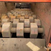 Industrial machinery with rows of large cylindrical rollers in orange metal frame