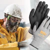 Construction worker in yellow jacket and safety gloves, wearing protective helmet and mask