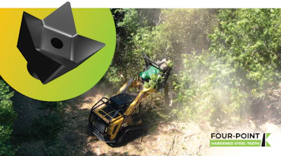 Yellow excavator working in forest clearing with dust and trees in background