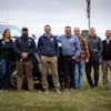 Chappell Tractor team standing beside company truck on grassy field