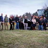 Government or municipal team posing with heavy equipment and American flag