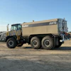 Large tan Hydex AWT6 articulated water truck on dirt construction site