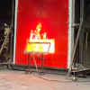 Fire resistance test with flames burning on red industrial testing panel