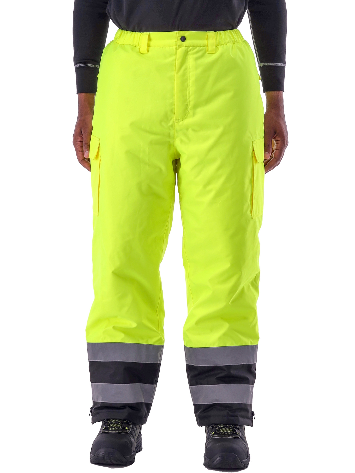 High-visibility safety pants in fluorescent yellow with reflective gray and black bands at bottom, featuring cargo pockets