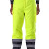 High-visibility safety pants in fluorescent yellow with reflective gray and black bands at bottom, featuring cargo pockets