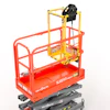 Red SkyJack scissor lift platform with yellow safety railings on gray base